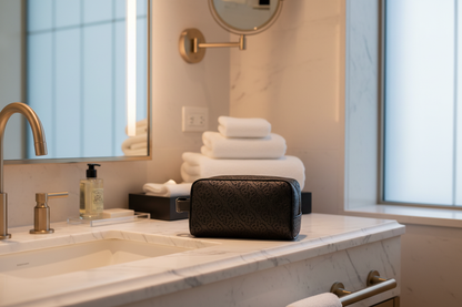 Rick Ross toiletry bag in luxury hotel bathroom